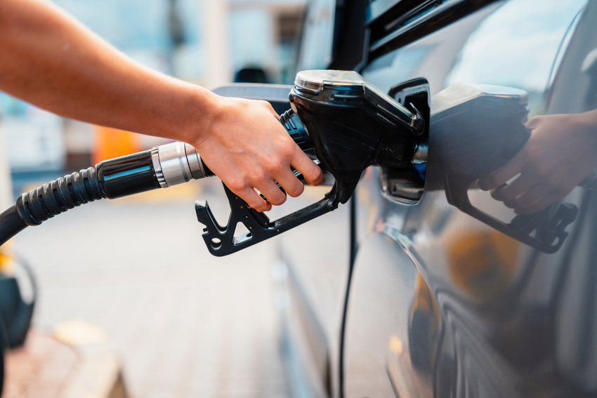 Close-up of person putting fuel into vehicle