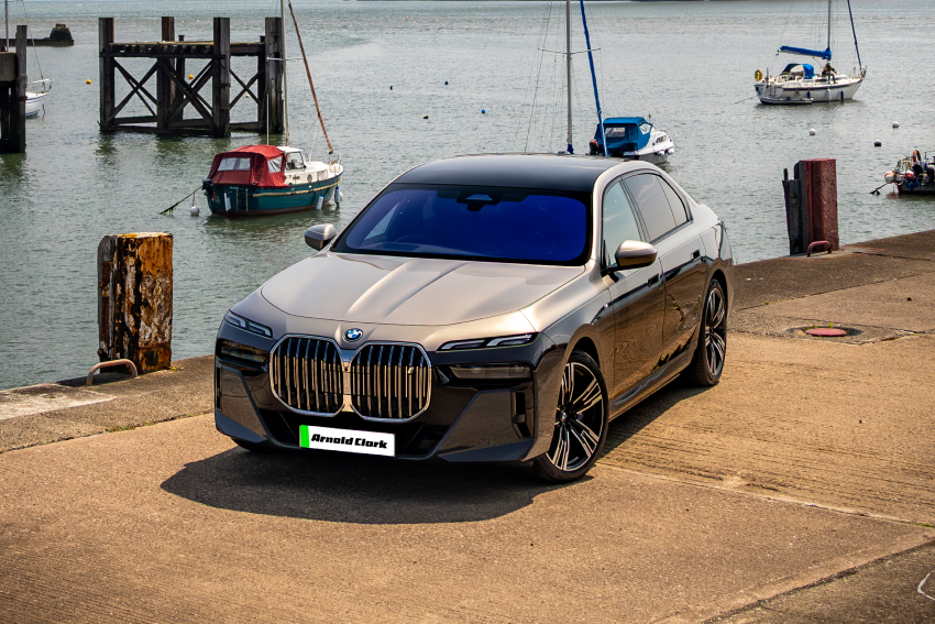 Angled front view of BMW i7 by dock side